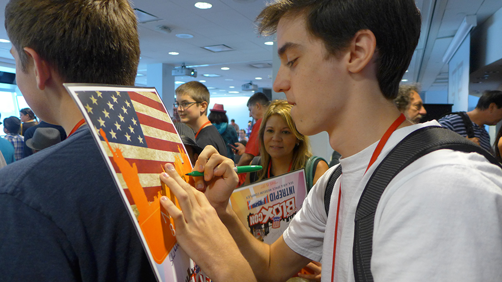 daxter33 (of Paintball! fame) signing BLOXcon posters on his friend's back!