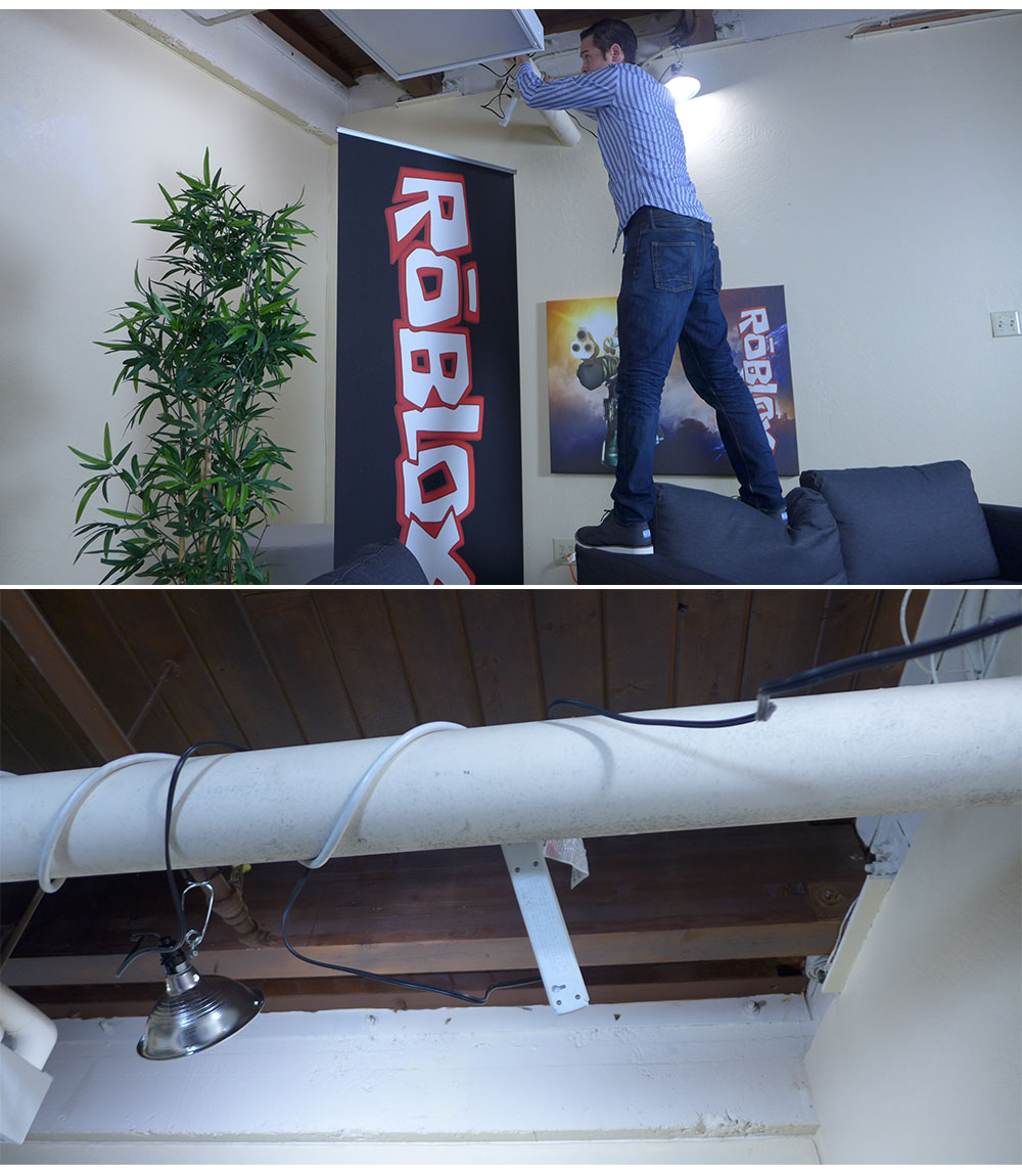 A bunch of wires are interlaced throughout the pipes in the ceiling.